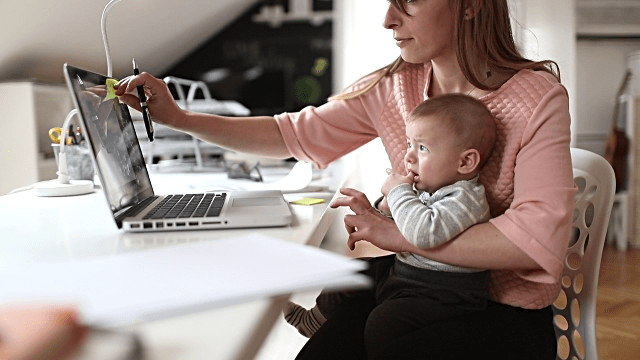 mom with baby managing her small business