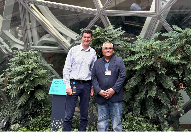 Globe CEO Carl Cruz (right) meets with Jan Hofmeyr, AWS Vice President of Telecommunications (left), in Seattle to discuss AI solutions and digital infrastructure for improving telco services.
